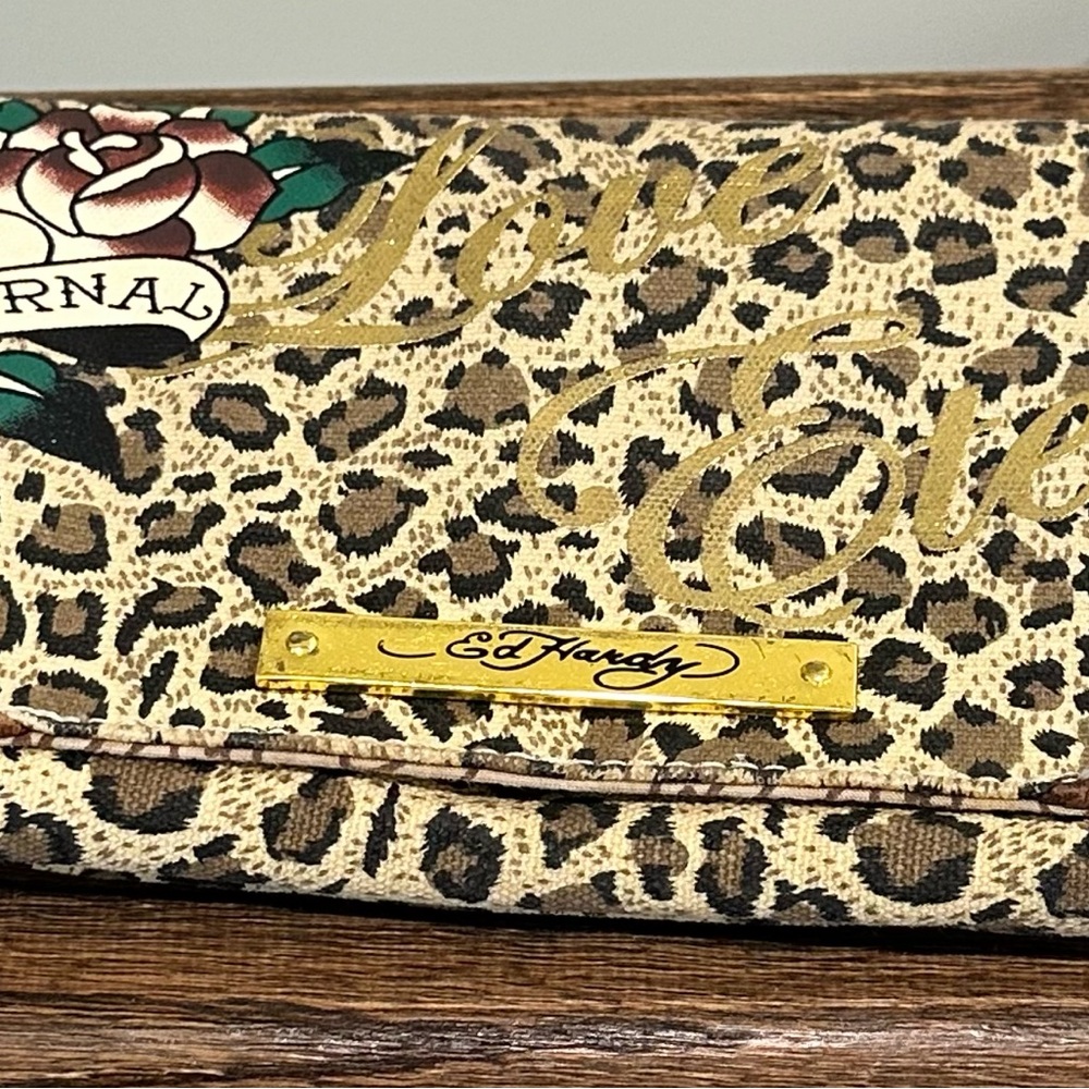 Ed Hardy clutch with wrist snap bracelet with connecting chain.